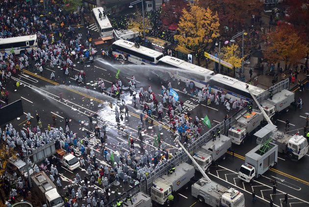 Police use water cannons to block South Korean protestors following a large rally against the government in downtown Seoul on November 14, 2015. Tens of thousands of people took to the street in central Seoul in a massive protest against the conservative government's drive for labour reform and state-issued history textbooks. AFP PHOTO / JUNG YEON-JE (Photo credit should read JUNG YEON-JE/AFP/Getty Images)
