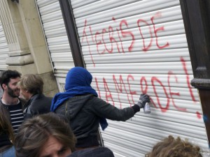 A demonstrator tags on a Ouest France office " You write shit", during a demonstration against the government's planned labour law reforms, in Rennes, on May 17, 2016. The Socialist government last week survived a vote of no-confidence, which was called by the centre-right opposition, after it forced through the labour market reform bill without parliament's approval. / AFP PHOTO / DAMIEN MEYER